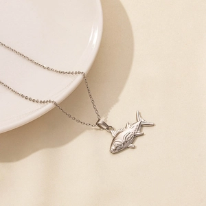 Detailed view of silver sea fish pendant in stainless steel with fine texture