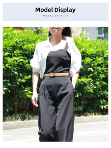 Fashionable summer outfit with black jumpsuit, brown leather belt, and white shirt layer