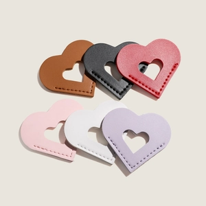 Detail view showing six heart-shaped PU leather bookmarks with visible stitching and texture