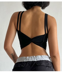Detail of cross knot back design on high-impact black sports bra for yoga and running