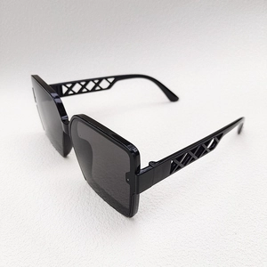 Detail of black oversized sunglasses with unique hollow woven design on the temples