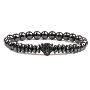 Detailed view of dark grey beaded bracelet featuring a leopard head with green eyes