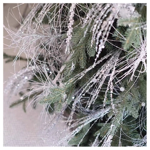 Close-up of silver glitter branch with translucent beads for Christmas tree decoration