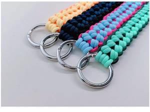 Detail of four colorful hand-woven nylon lanyards with silver round metal clasps