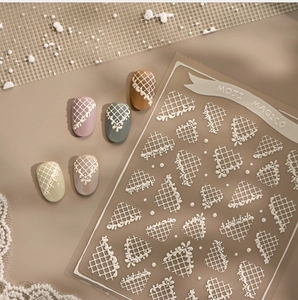 Detailed view of 3D embossed white lace nail stickers on various colored display tips