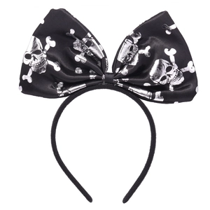 Detail of Halloween black satin headband featuring a silver skull and crossbones bow