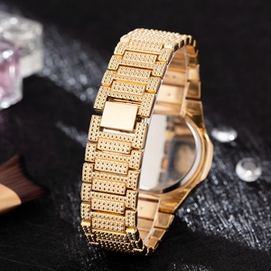 Close-up of golden watch strap with fine dotted texture and elegant invisible clasp