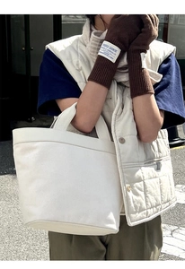 Detail shot of brown wool knit gloves featuring a vintage logo patch and long wrist cuff