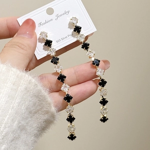 Detailed macro view of S925 silver needle long tassel earrings with sparkling zircon stones