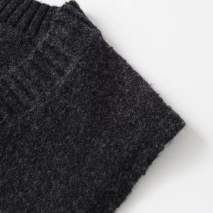 Sleeveless V-neck knitted vest sweater in black color showing close-up texture