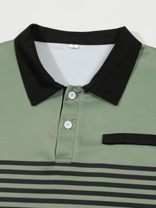 Close-up of the knitted mesh fabric and polo collar detail on a men's striped polo shirt