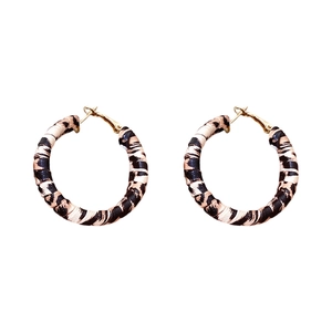 Retro leopard print leather hoop earrings with gold metal accents on white background