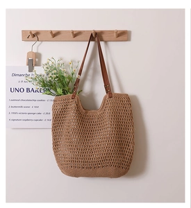 Detail of hollow woven cotton mesh shoulder bag with premium dark leather straps