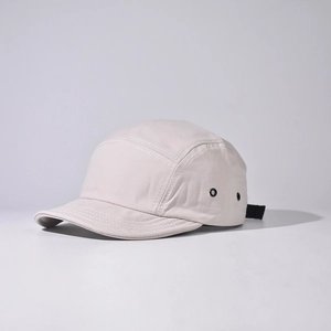 Detail of five-panel camper hat with metal eyelets and adjustable strap buckle