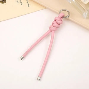 Pink braided PU leather key ring with silver hardware on a clean minimalist background