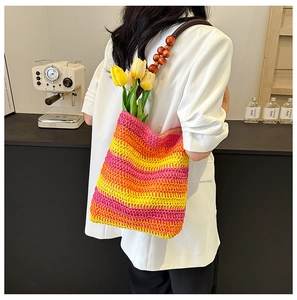 Rainbow woven bucket bag with wood bead handles styled with a white blazer