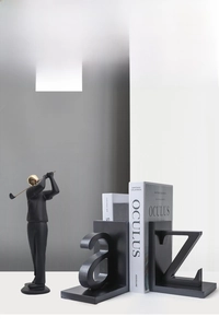 Detail of modern black golf player statue with gold accents and A-Z letter bookends