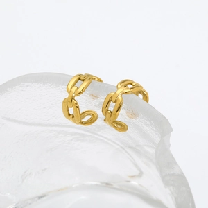 Detailed macro shot of 18K gold plated double layer chain ear cuffs on ice texture background