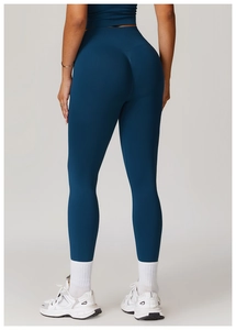 Detailed back view of high-waist scrunch butt yoga leggings in dark teal seamless fabric