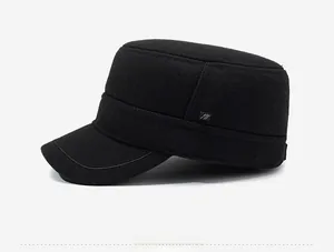 Detail view of black wool blend flat top military cap with square metal logo accent