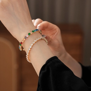 Detailed shot of gold plated tennis bracelets with white and multi-colored cubic zirconia