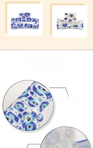 Detail showing smooth evil eye hair claw clip with pearlescent finish and blue motifs