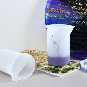 Detailed view of graduated silicone measuring cups with eagle beak for resin art mixing