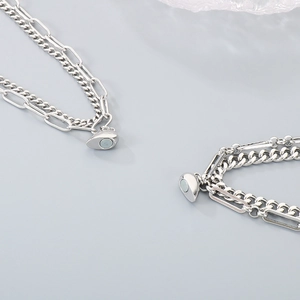 Detail of silver stainless steel double-layered magnetic heart coupling bracelets
