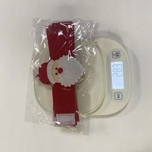 Detailed weight measurement showing 28.3g for a Santa Claus fabric napkin ring