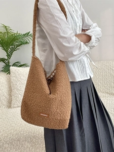 Brown fuzzy sherpa tote bag with leather logo patch and checkered lining for autumn winter