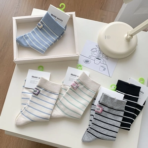 Set of five colorful striped cotton crew socks with knit texture and minimal packaging