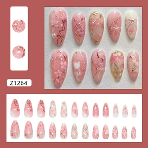 Pink press-on nails with 3D floral, pearl, and cat designs in a 24-piece full set pack