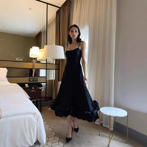 Elegant black A-line spaghetti strap dress with ruffled hem for evening parties