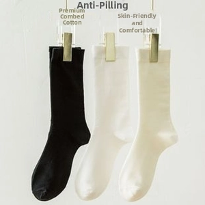 Three pairs of combed cotton mid-calf socks in black, white, and beige with ribbed cuffs