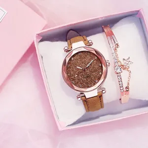 Detail of rose gold ladies' watch with starry dial and matching star bracelet in gift box