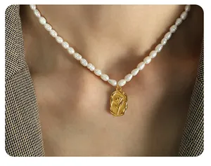 Detail of freshwater pearl necklace with gold oval rose relief pendant on a model