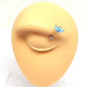 Curved stainless steel barbell with three blue opal stones on a silicone display