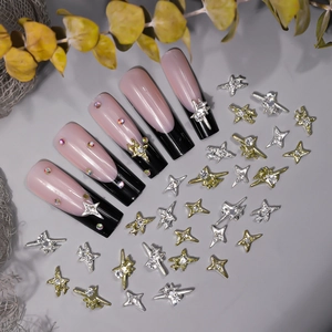 Detailed macro view of 3D Y2K star and cross metal nail charms with diamond accents