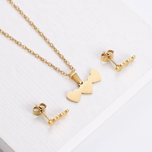 Detailed view of golden stainless steel jewelry set with heart necklace and stud earrings