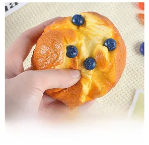 Macro shot of a squishy artificial blueberry muffin toy showing realistic soft texture