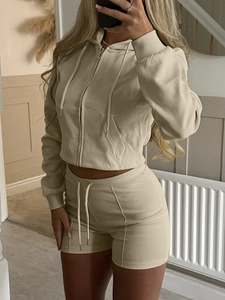 Detail of apricot cropped zip-up hoodie and matching shorts in soft cotton blend fabric