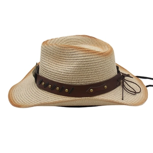 Detail of western straw cowboy hat featuring faux leather band and metal rivet accents