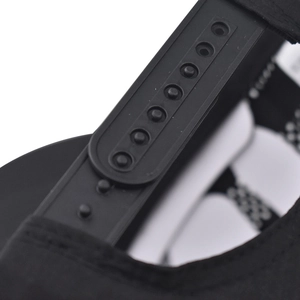 Detail view of the black plastic snapback closure on a baseball cap with adjustable holes