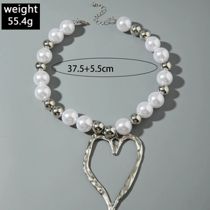 Detail view of heart pendant necklace with faux pearls and size specifications