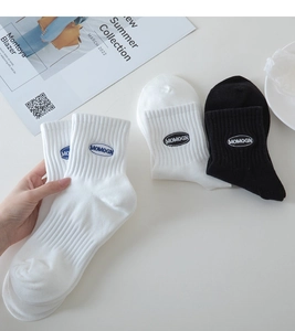 Close-up of MOMOGN embroidery on white and black cotton ribbed crew socks for men and women