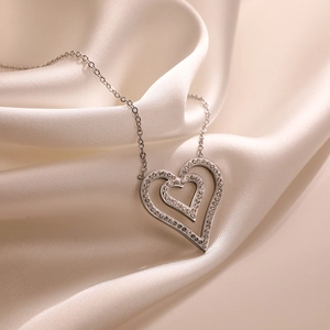 Double-layered silver heart pendant necklace with zircon on elegant silk fabric