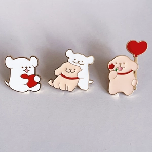 Close-up of three cartoon dog alloy pins with gold borders and heart balloon details