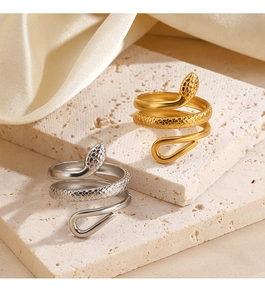 Detailed macro view of snake rings featuring gold and silver finishes with scale textures