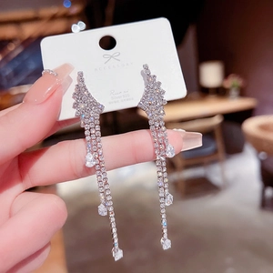 Detail view of long tassel earrings with sparkling crystals and S925 silver needles
