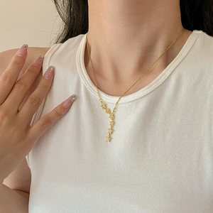 Elegant gold titanium steel necklace featuring five sparkling star pendants on the collarbone